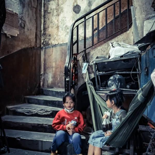 2 kids at the bottom of the stairs